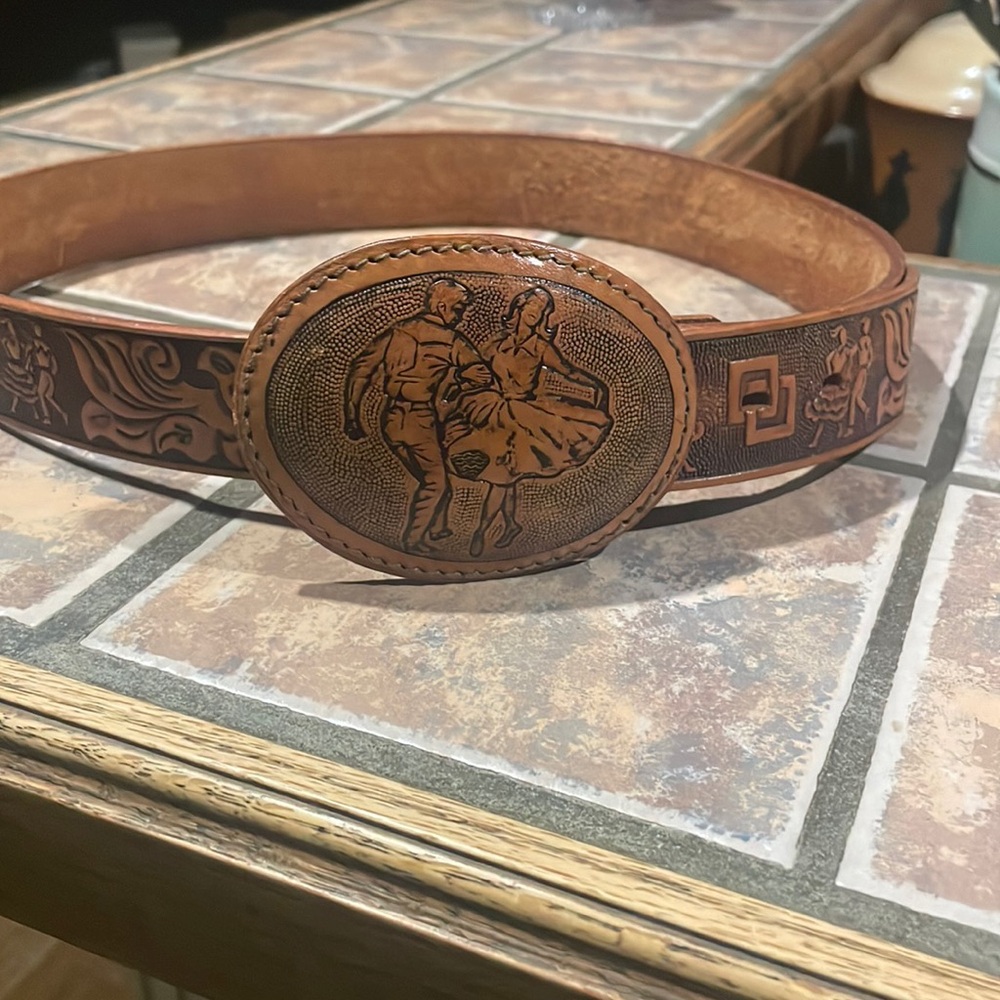 Hand tooled leather belt with square dancers on buckle.